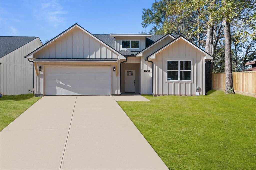 a front view of a house with yard and green space