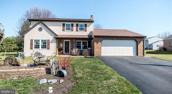 a front view of a house with a yard outdoor seating and barbeque oven