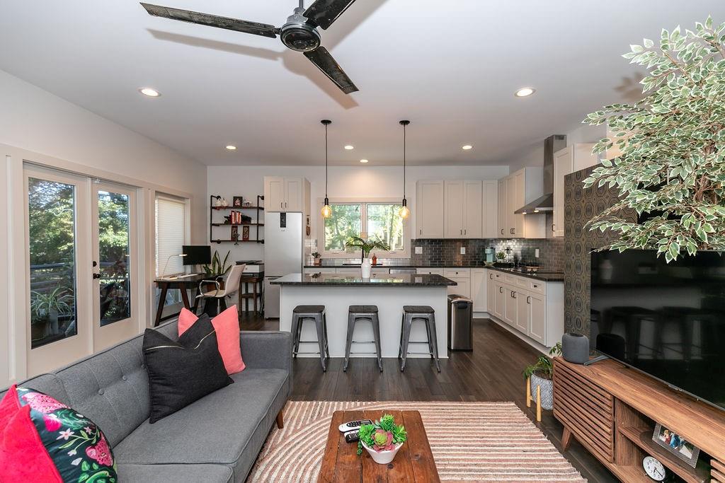 a kitchen with counter top space view and living room