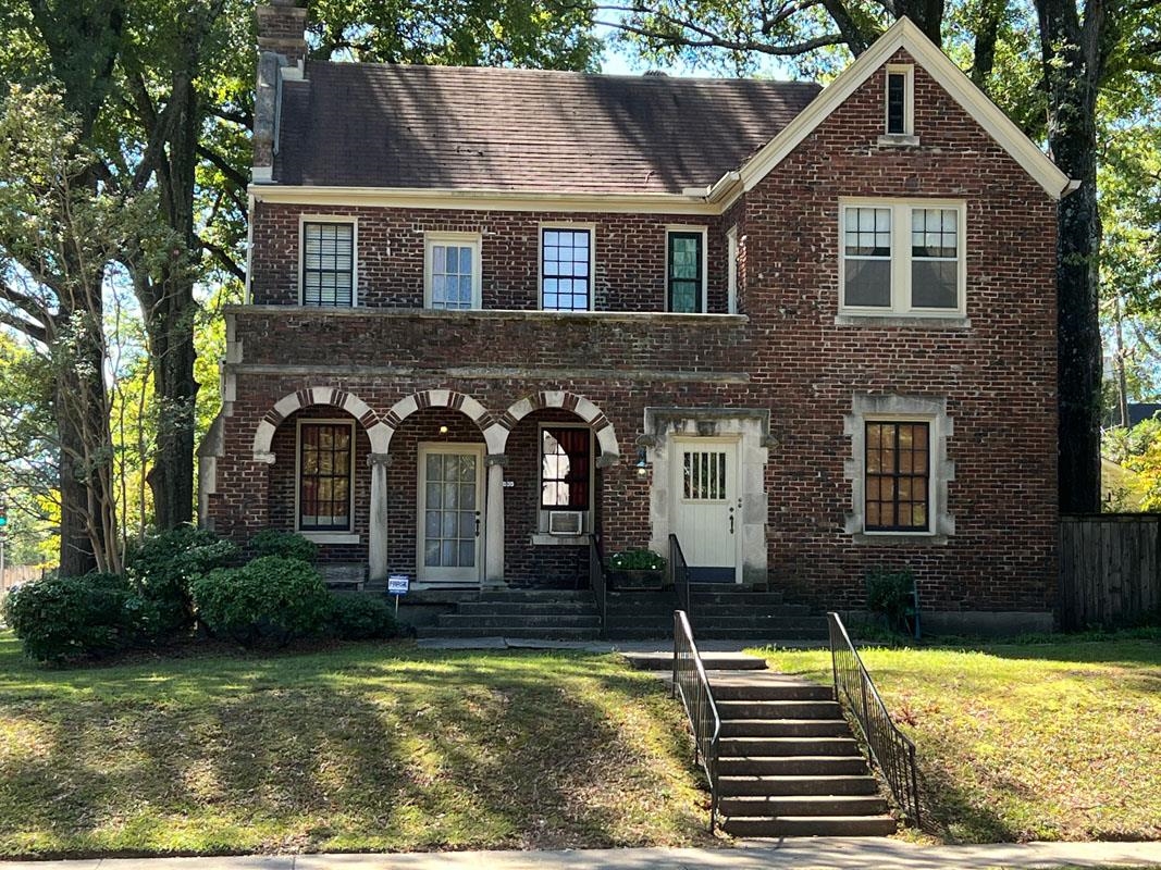 View of front facade with cooling unit and a front lawn