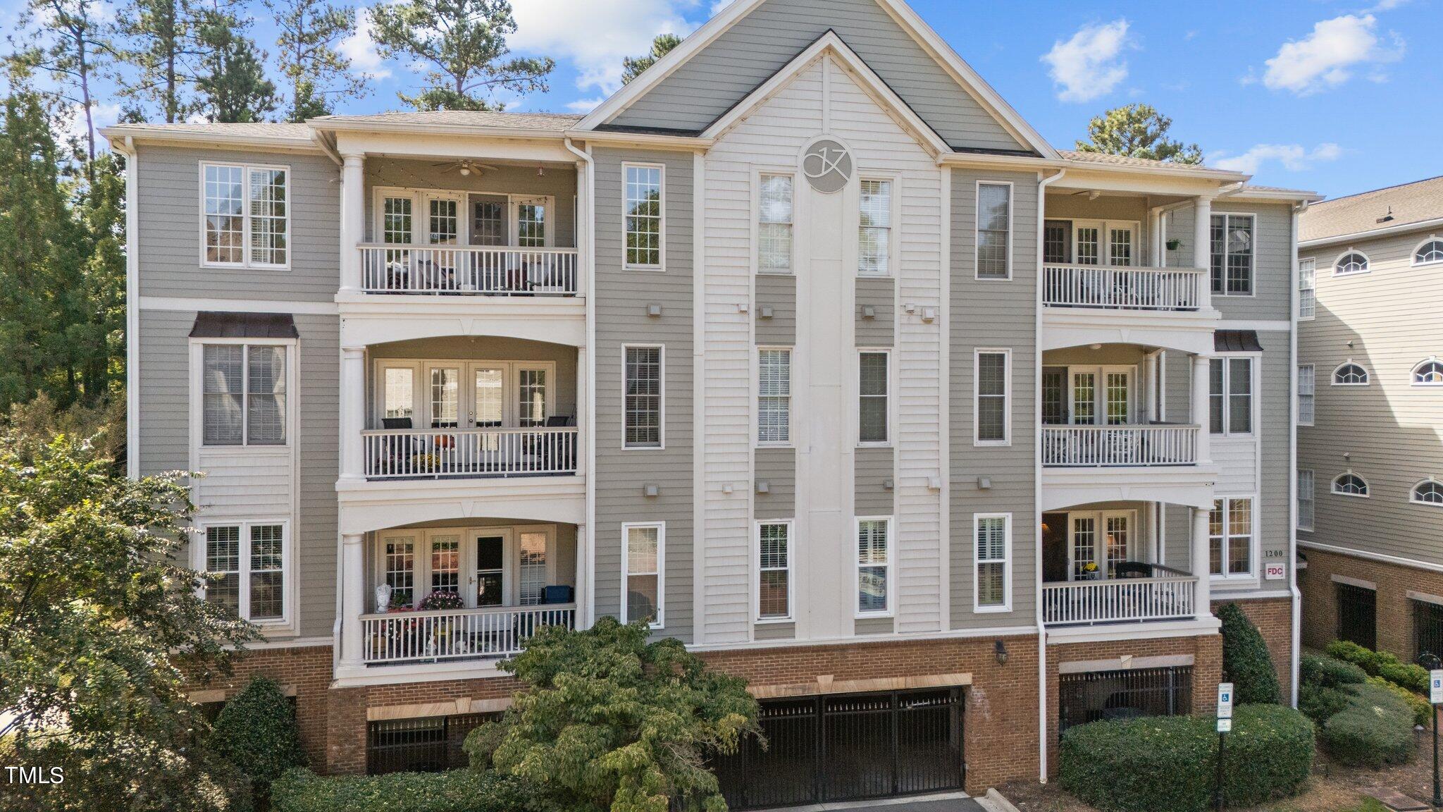 a front view of a residential apartment building with a yard