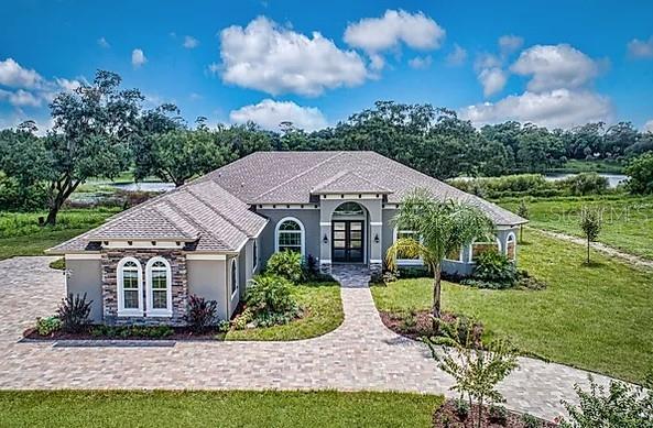 a aerial view of a house next to a yard