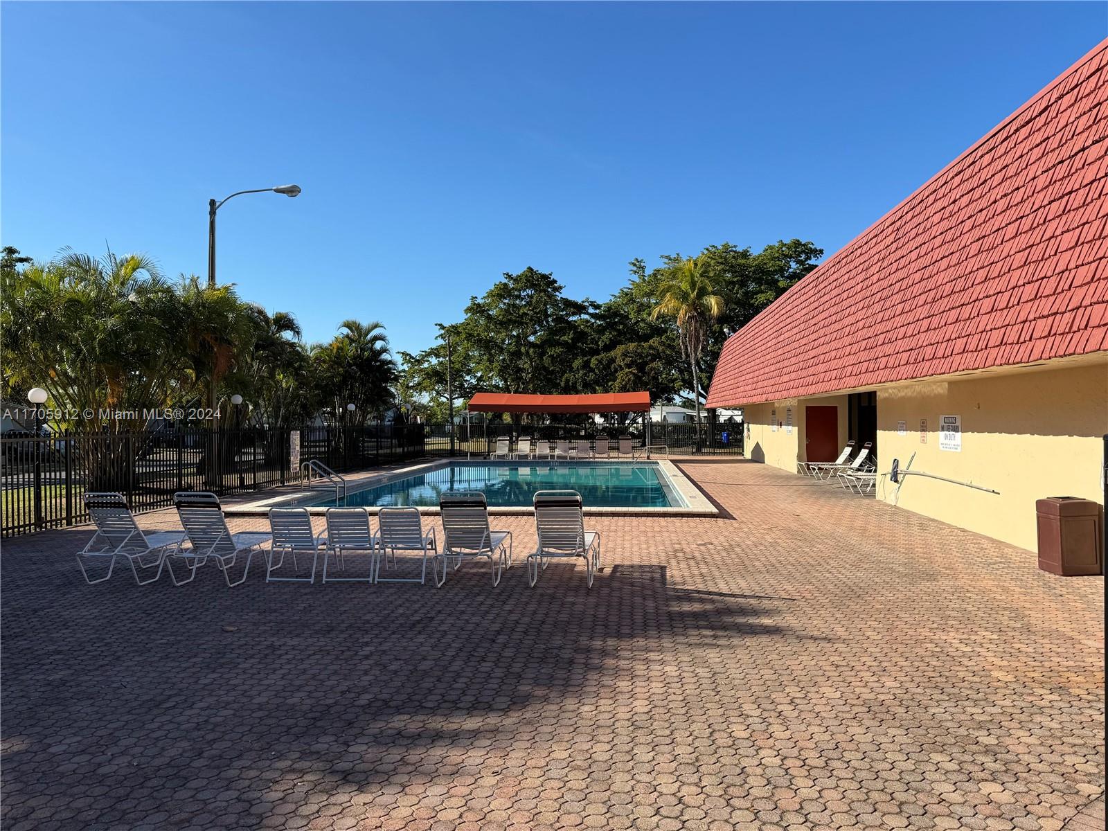 a view of a swimming pool with sitting area