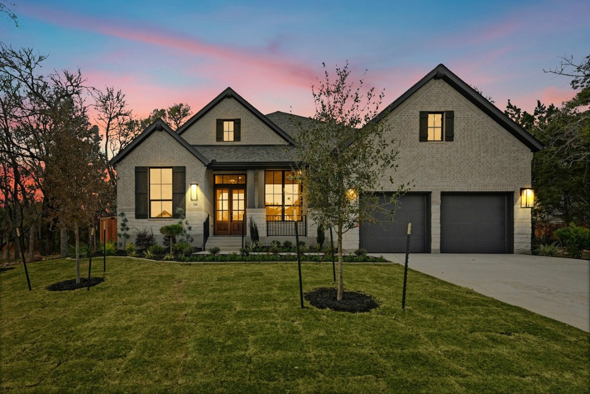 a front view of a house with a garden