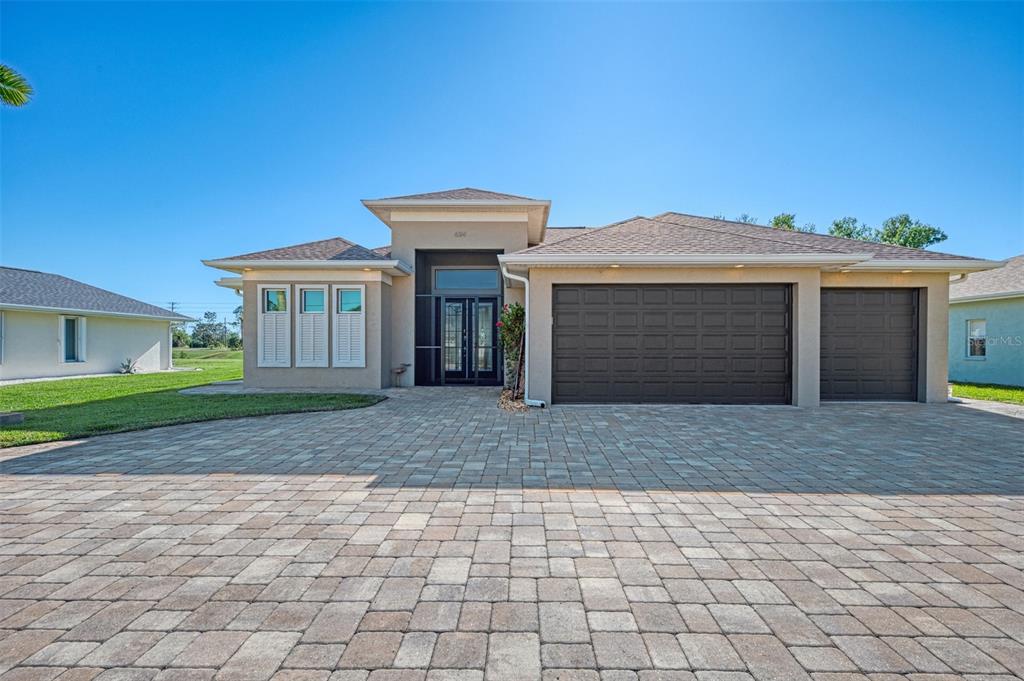 a front view of a house with a yard and garage