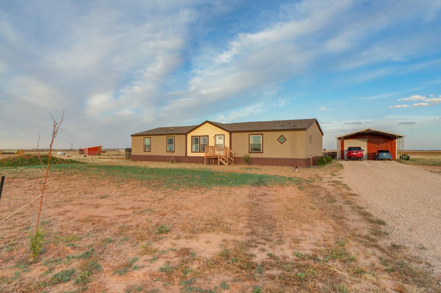 a front view of house with yard and car parked