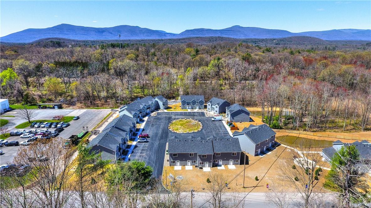 an aerial view of a house with yard swimming pool and mountain view