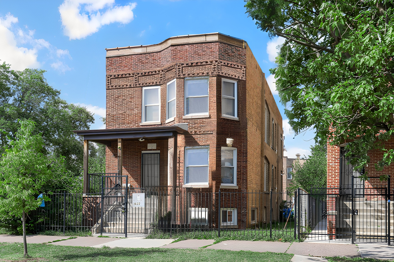 a view of a brick building next to a yard