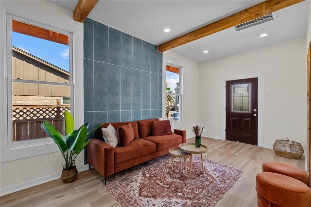 a living room with furniture and a potted plant