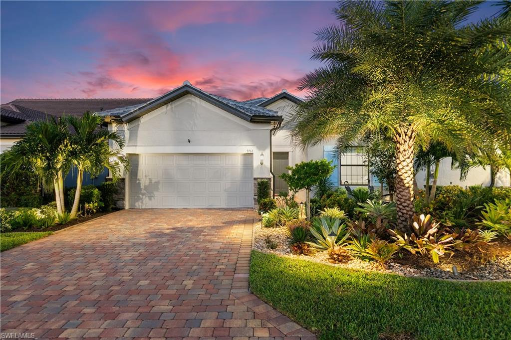 a front view of a house with a yard and garage