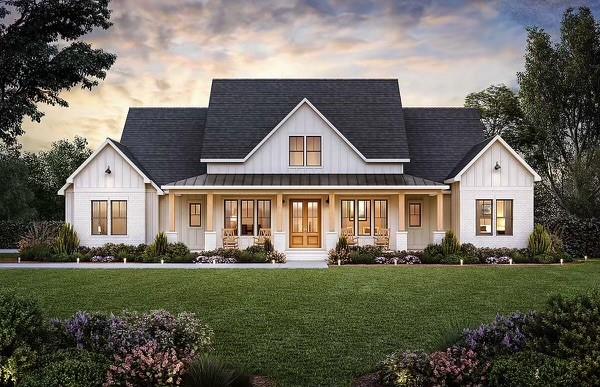 a front view of a house with a garden and plants