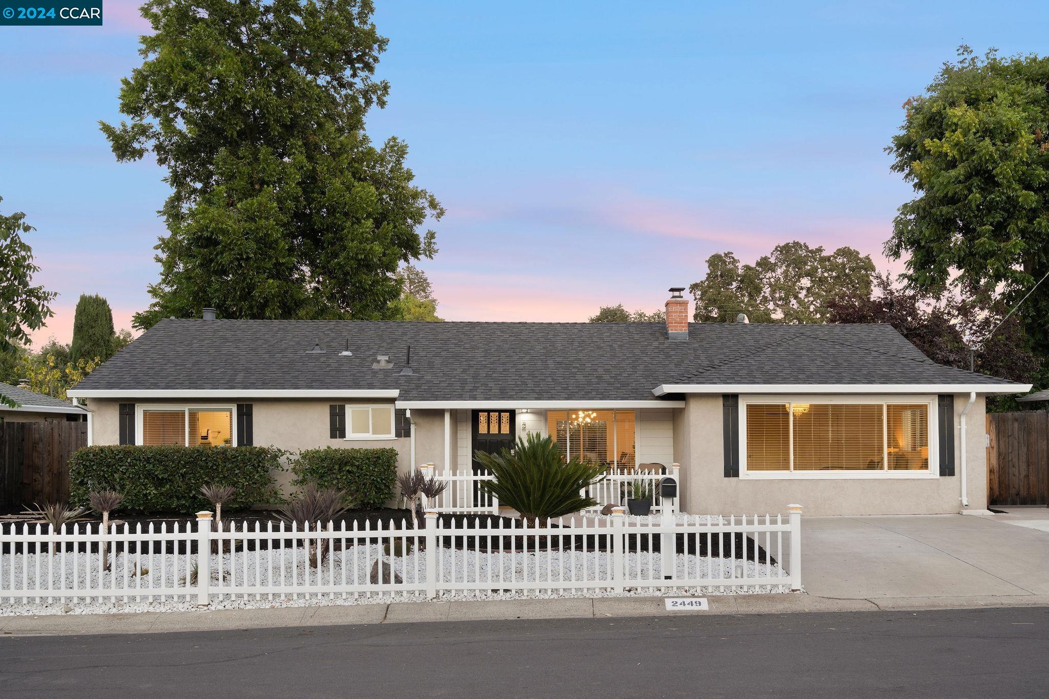 a front view of a house with a fence