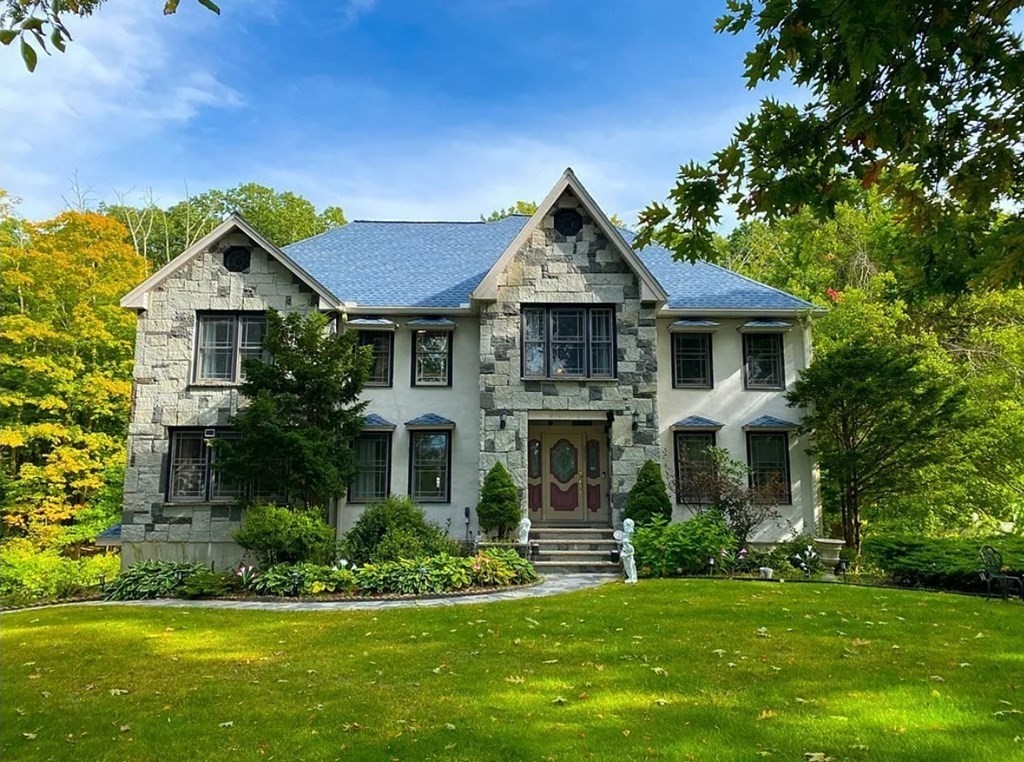 a front view of a house with a yard