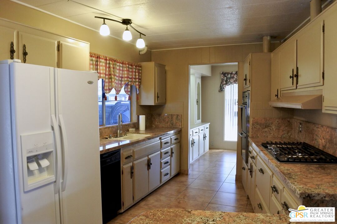 a kitchen with stainless steel appliances a refrigerator a stove and a sink