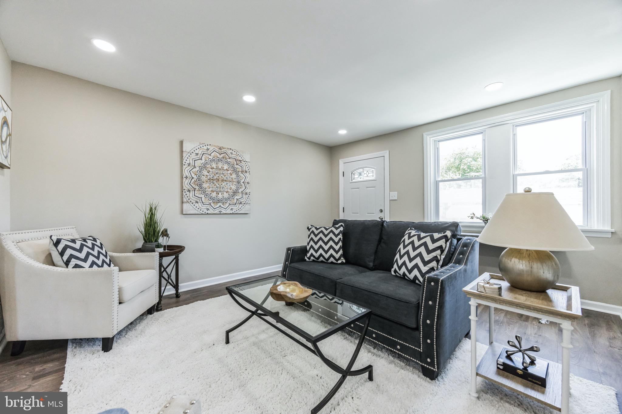 a living room with furniture and a lamp