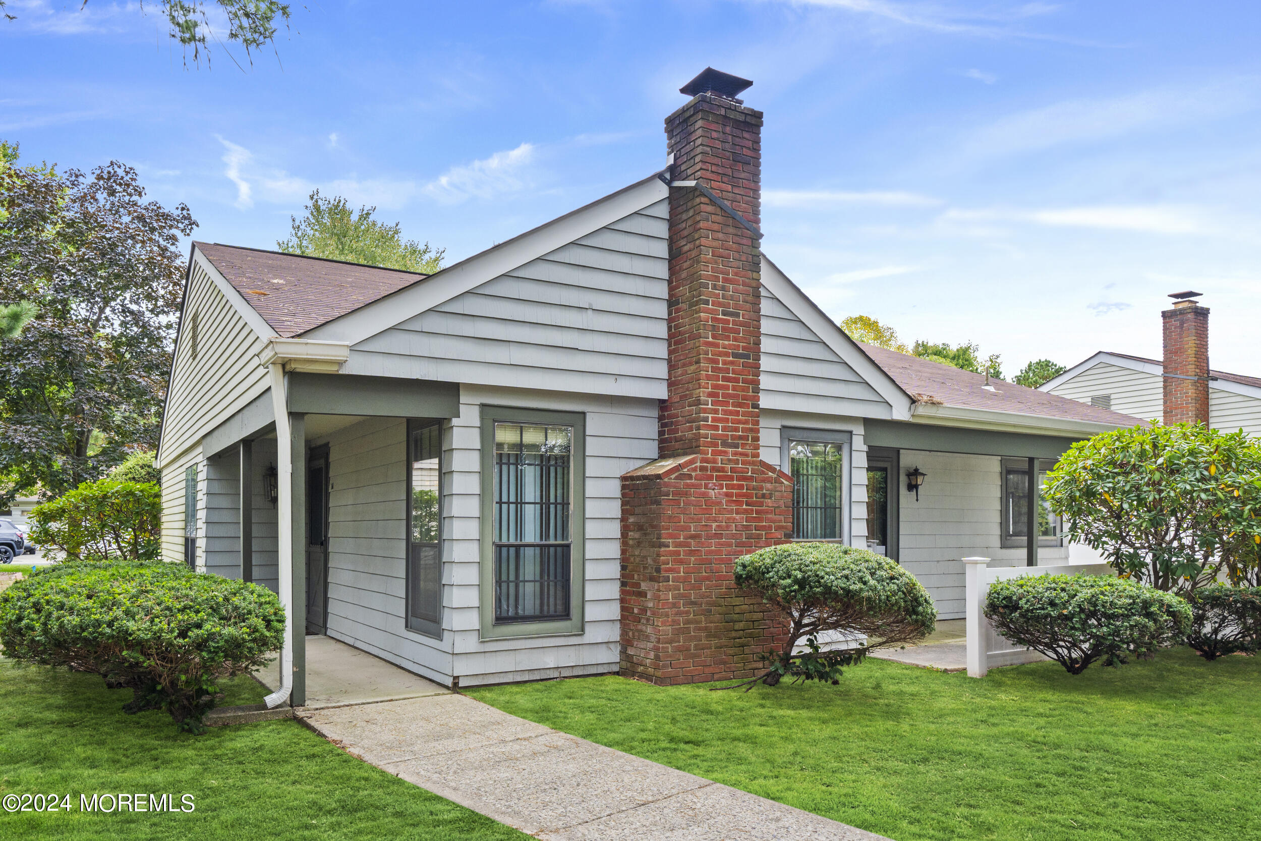 a front view of a house with garden