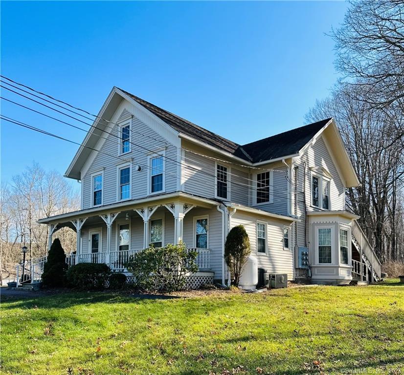 a front view of house with yard and green space