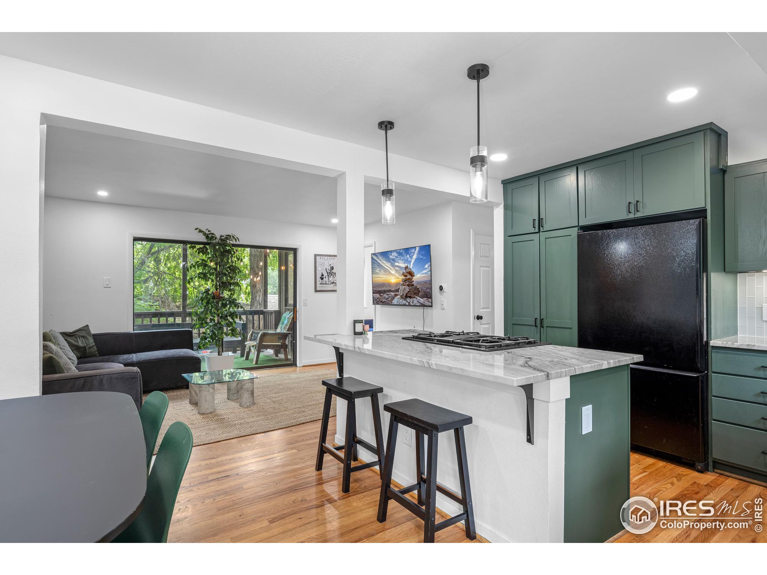 a kitchen with kitchen island a counter top space appliances and a dining table