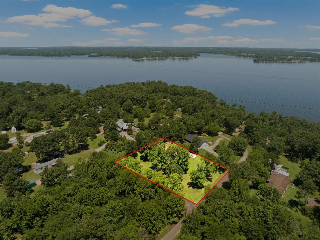 an aerial view of a houses with a lake view