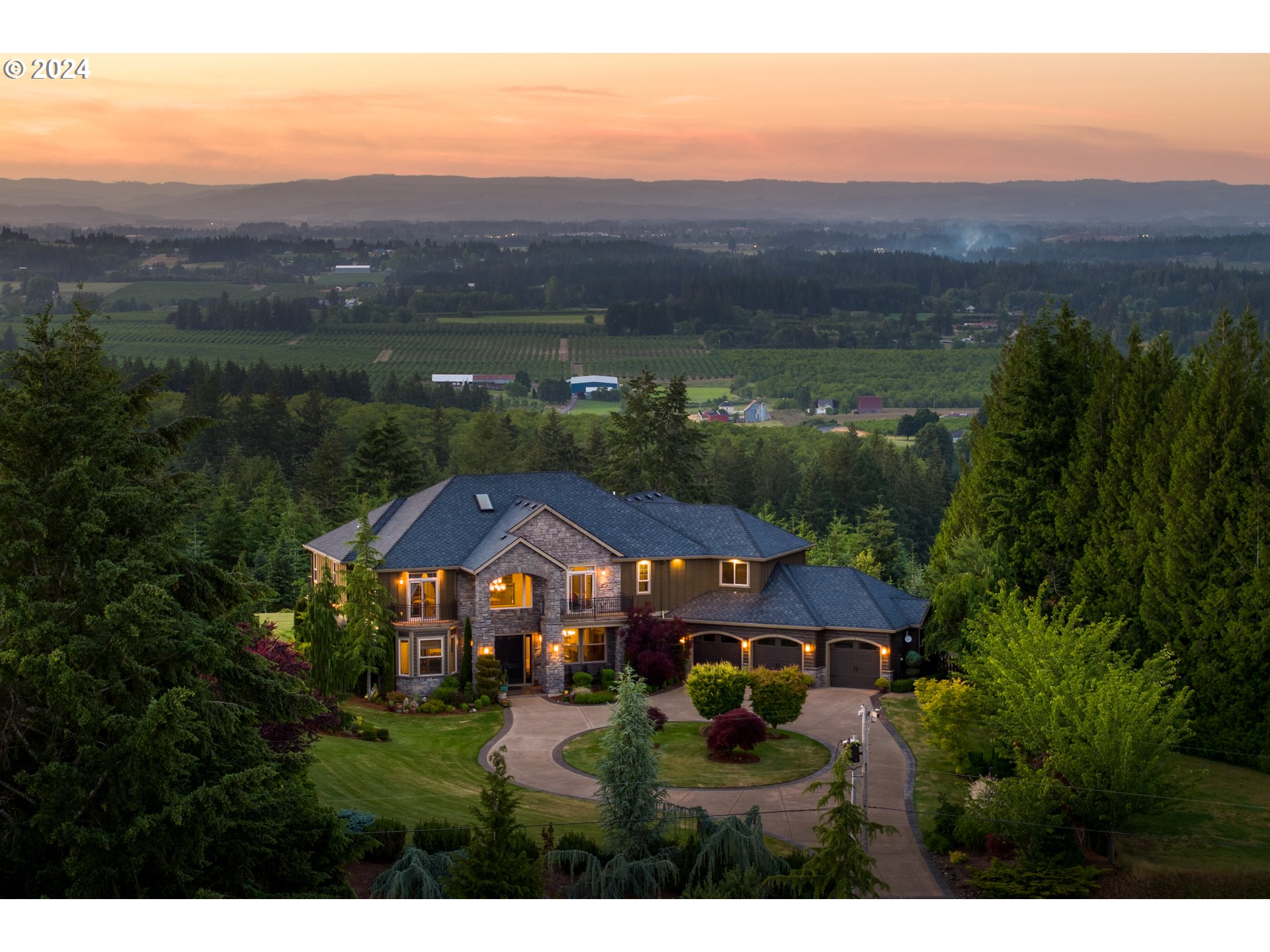 a view of house with garden and mountain view