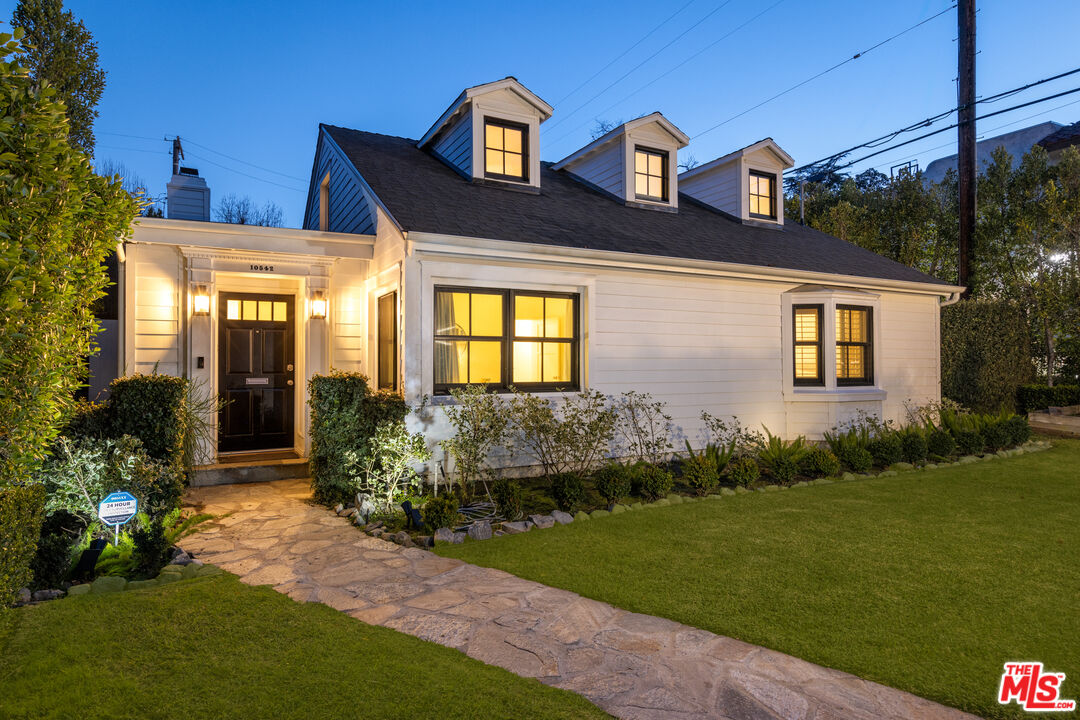 a front view of a house with garden