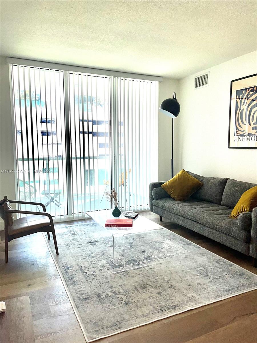 a living room with furniture and a large window