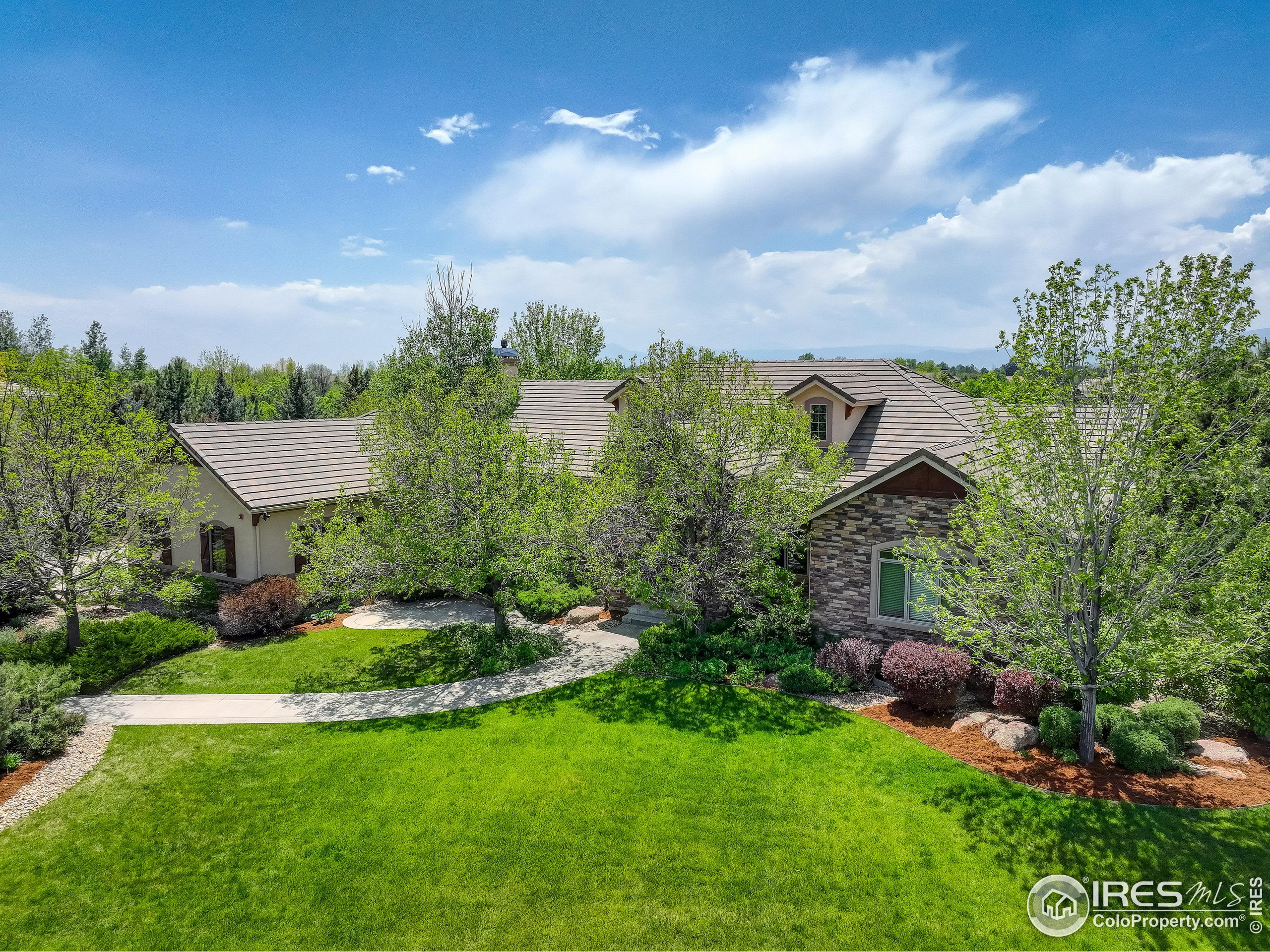 an aerial view of a house with a yard