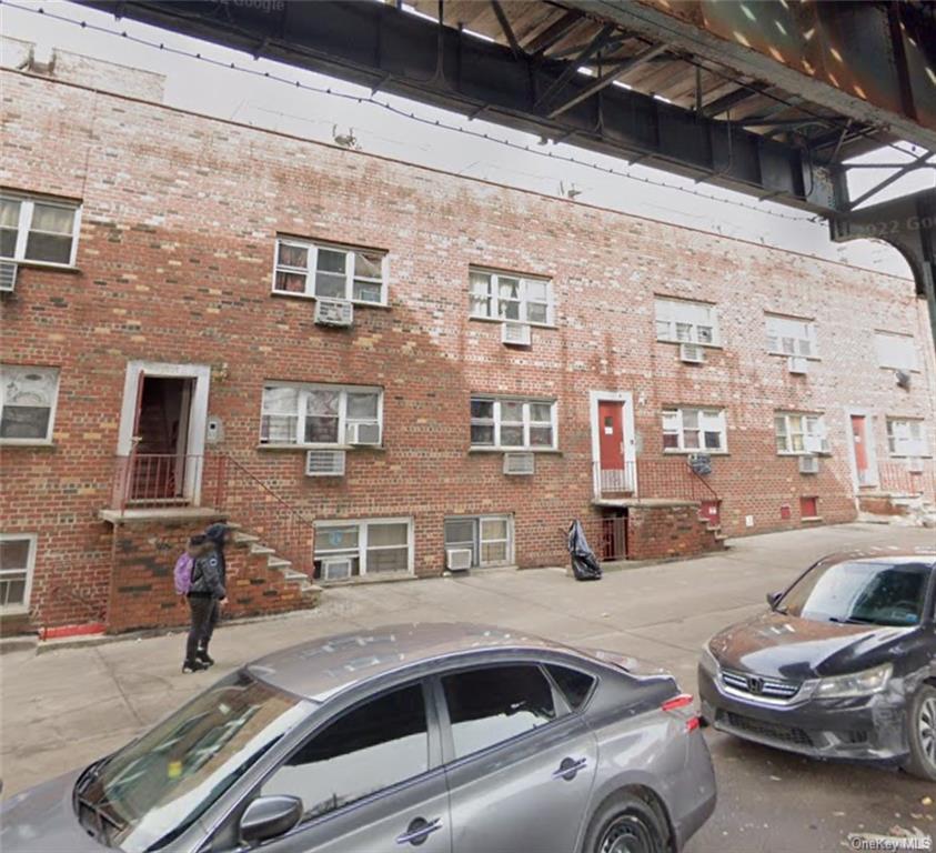 a view of a street that has couple of cars parked in front of it