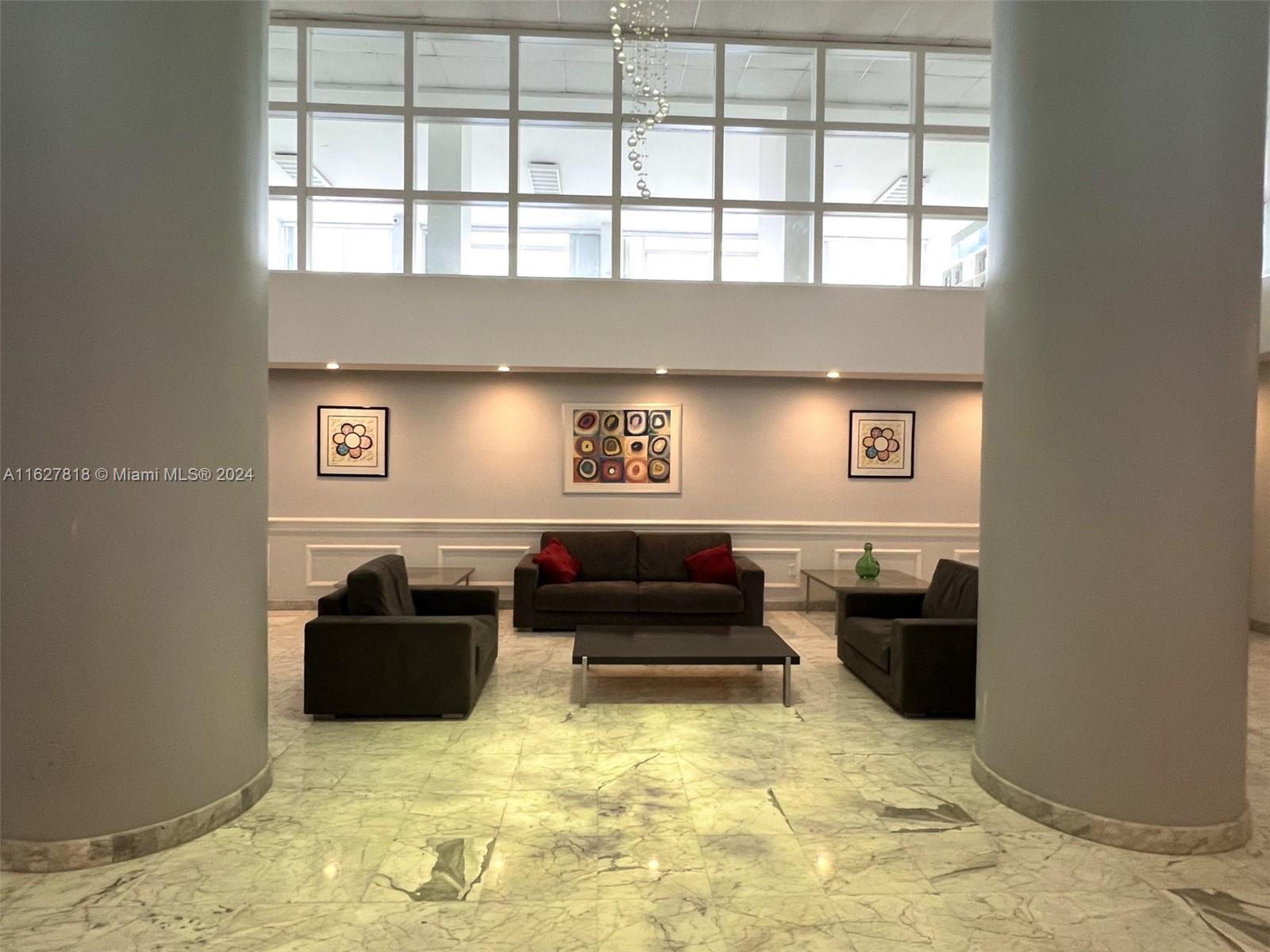 a living room with furniture window and a flat screen tv