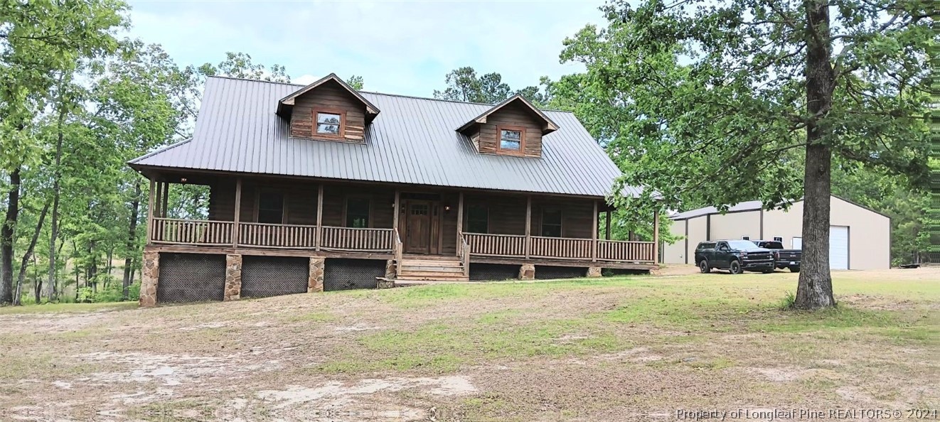 a view of a house with a yard and sitting area