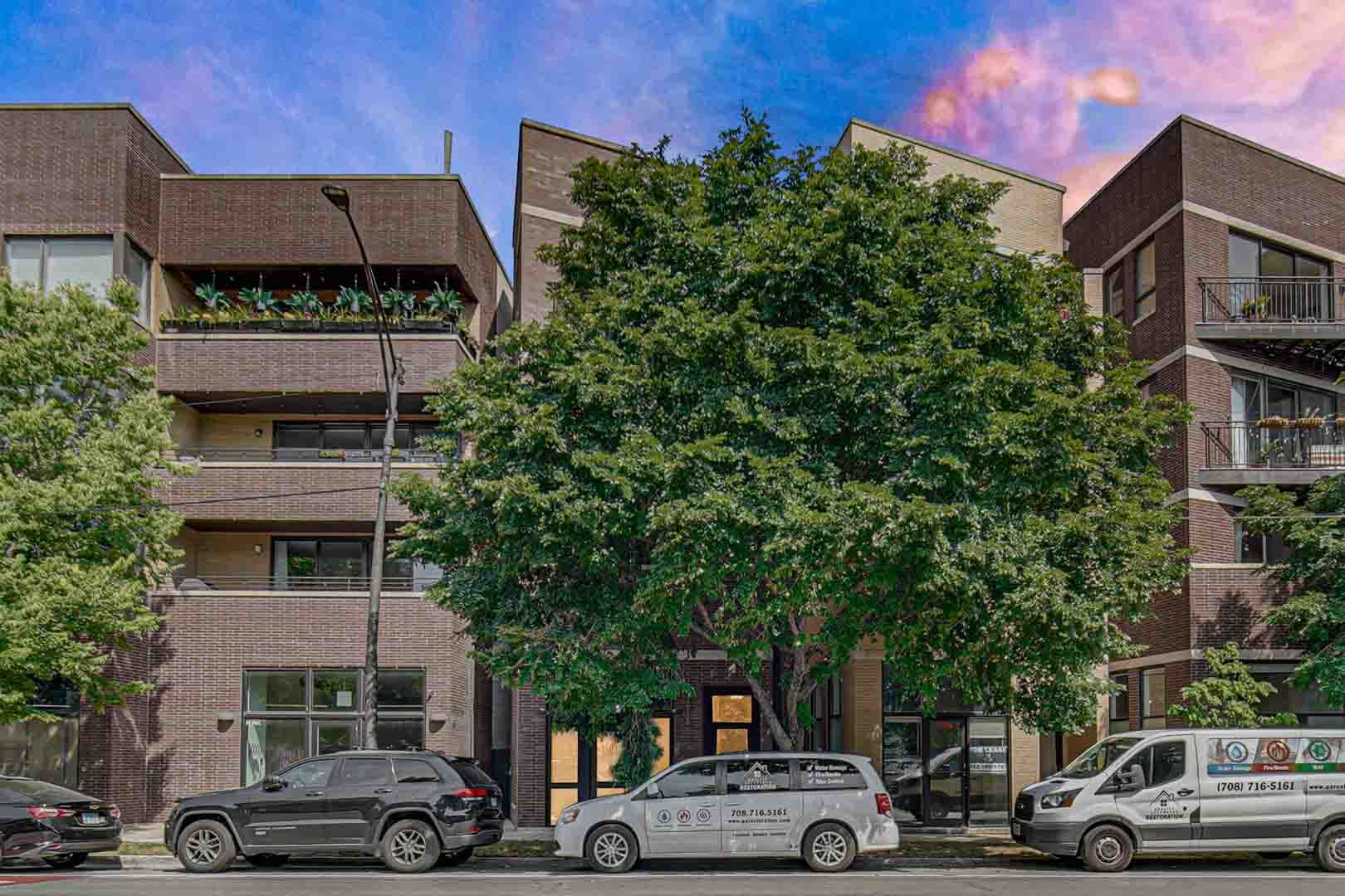 a front view of a building with trees