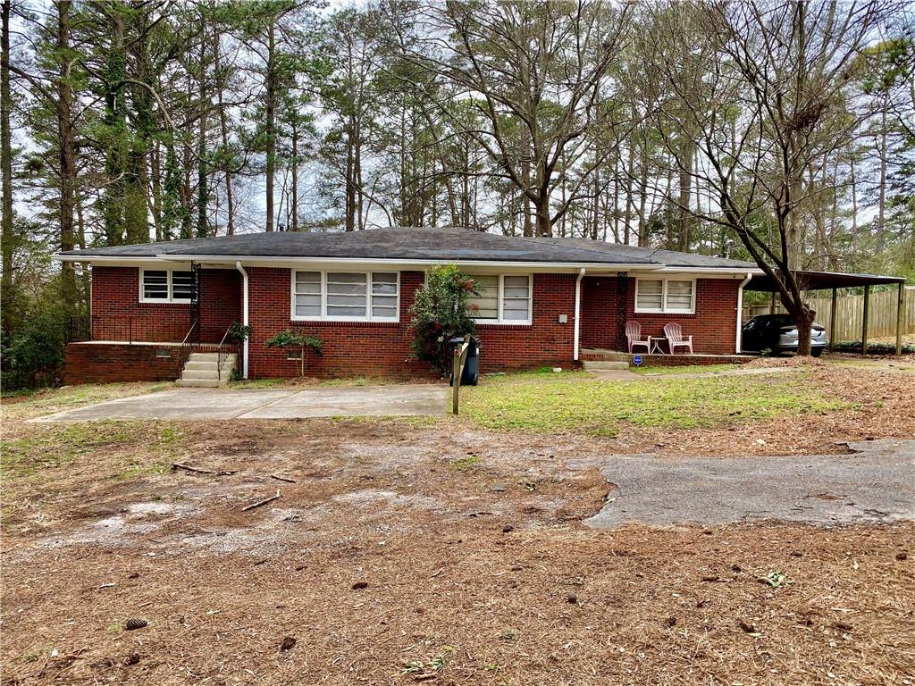 a front view of house with yard and green space