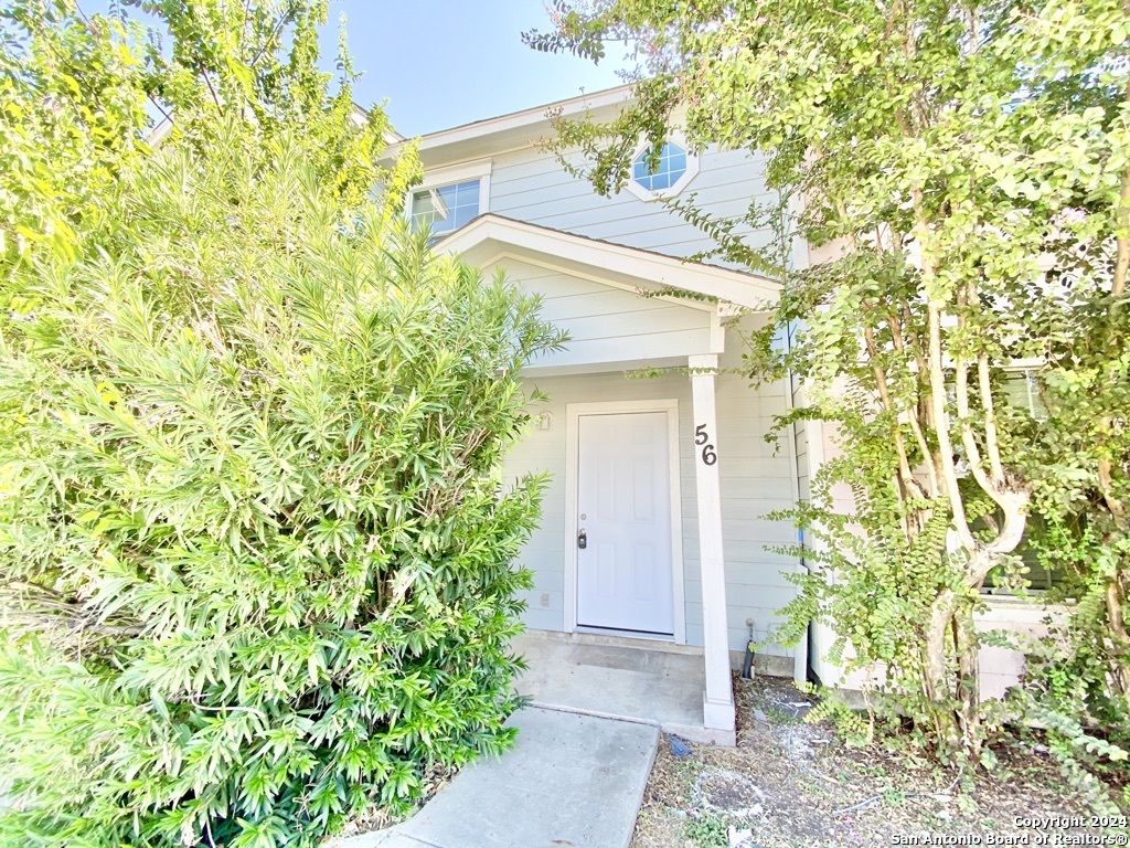 a view of a house with a tree