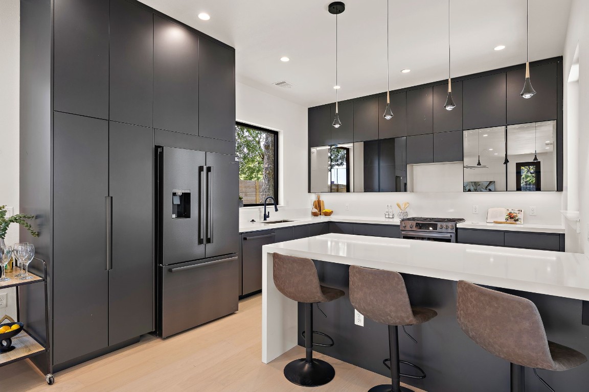 a large kitchen with a table and chairs