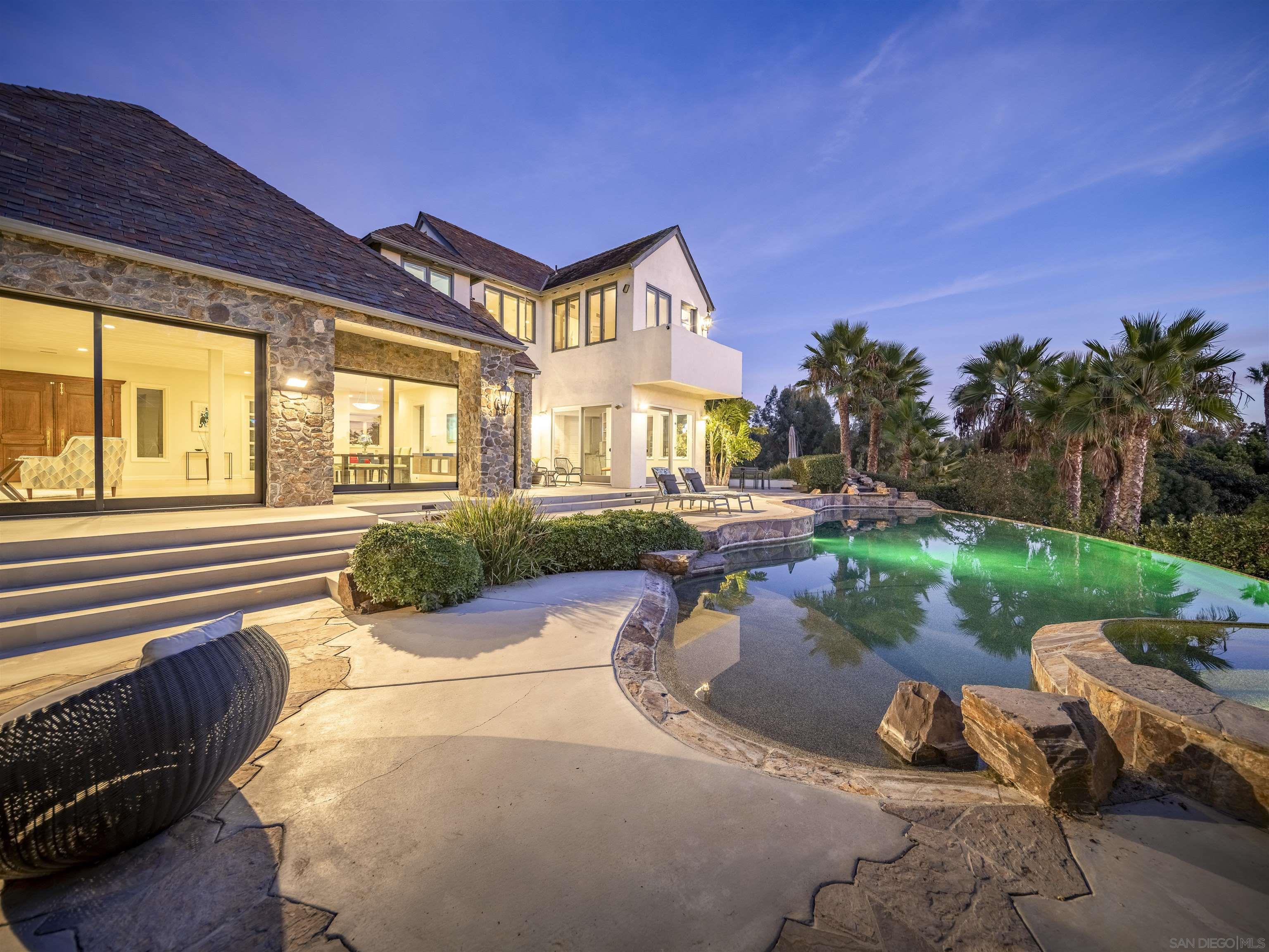 a front view of a house with a yard fire pit and outdoor seating