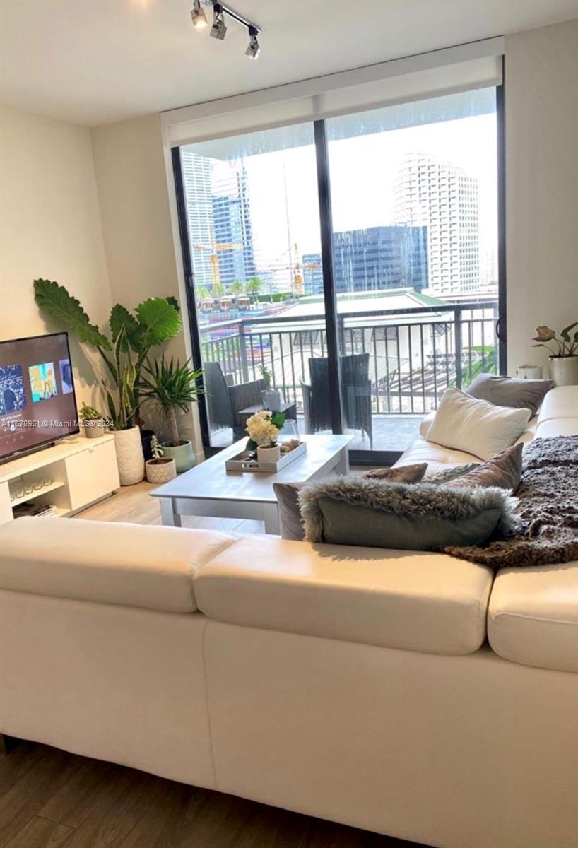 a living room with furniture and large windows