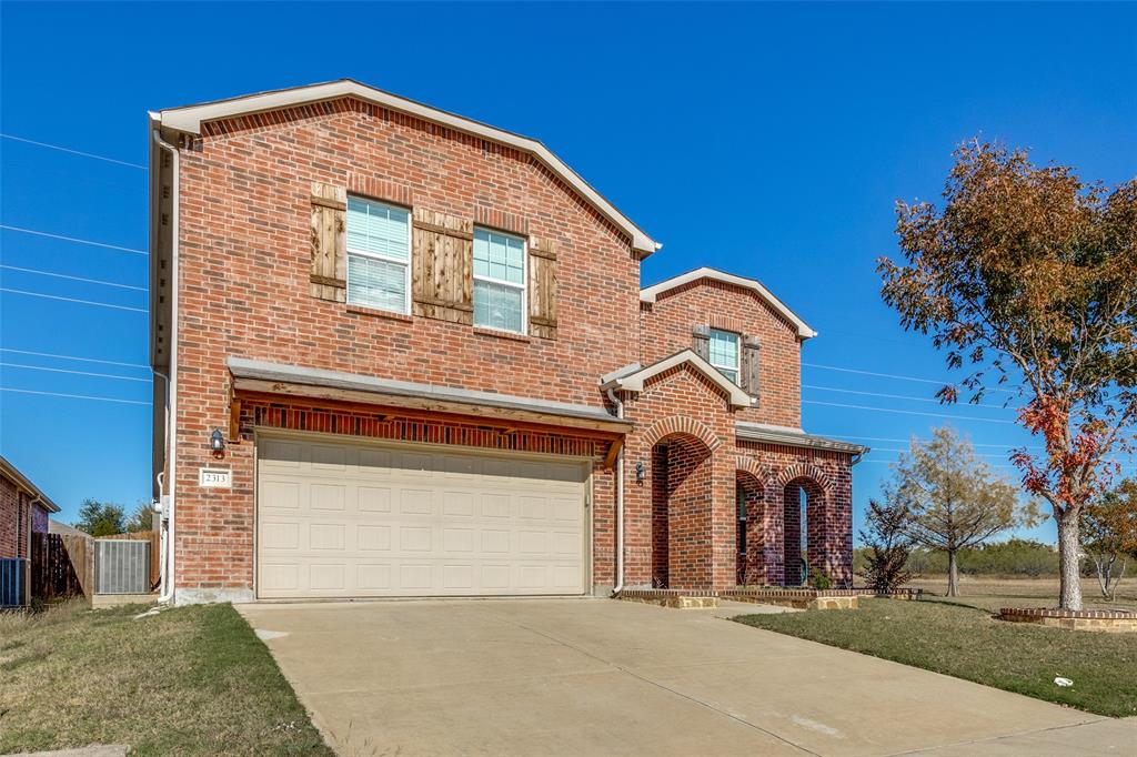 Front of property featuring a garage and central AC