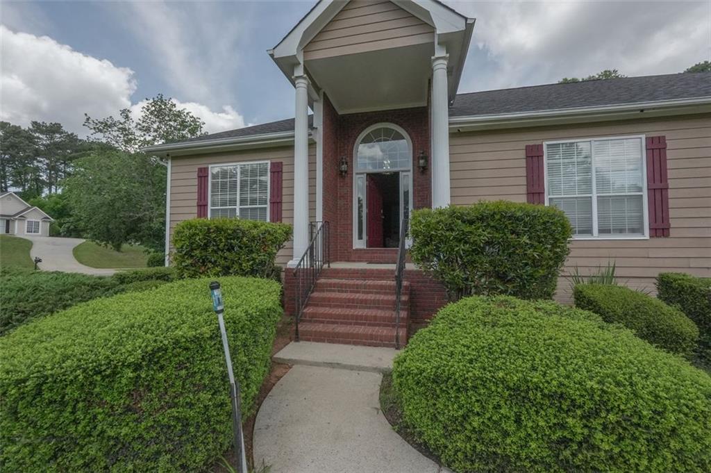 a front view of a house with garden