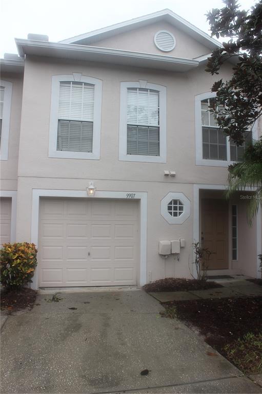 a front view of a house with garage