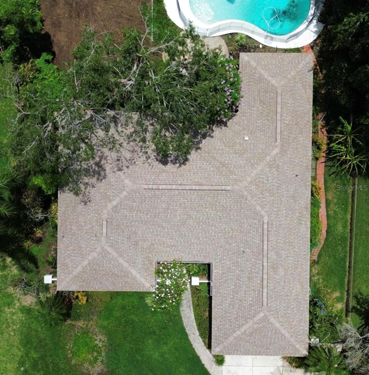 an aerial view of a house with a yard and garden