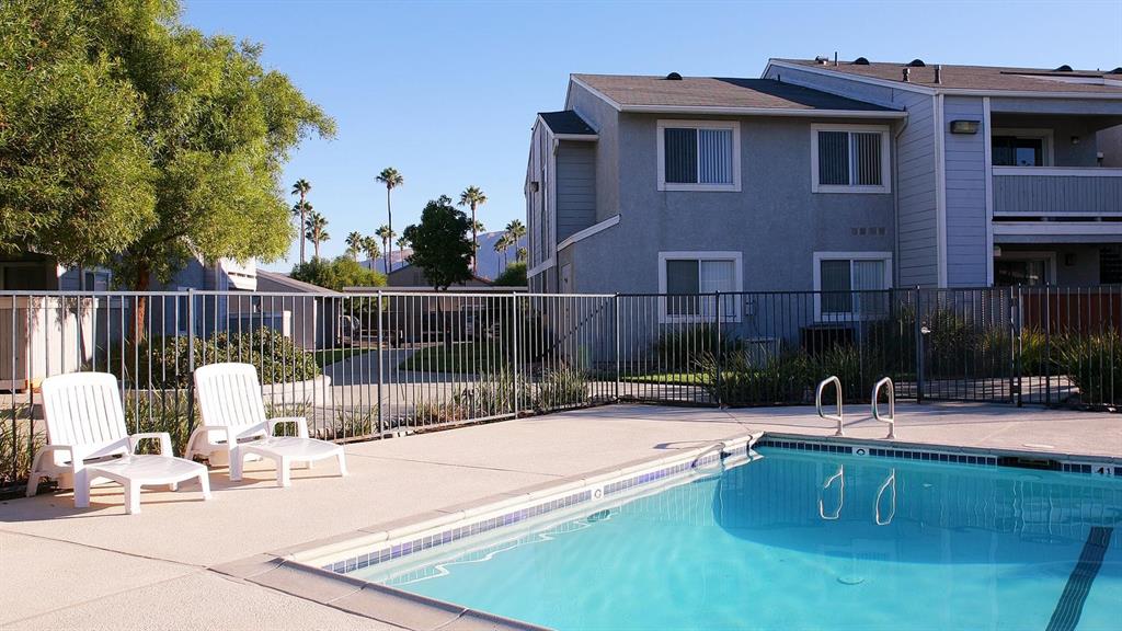 a swimming pool with outdoor seating and yard