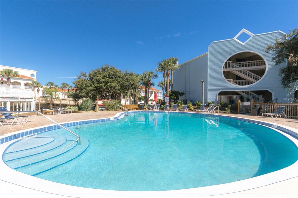 a swimming pool with trees in the background