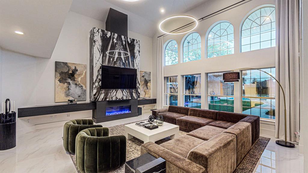 a living room with furniture fireplace and flat screen tv