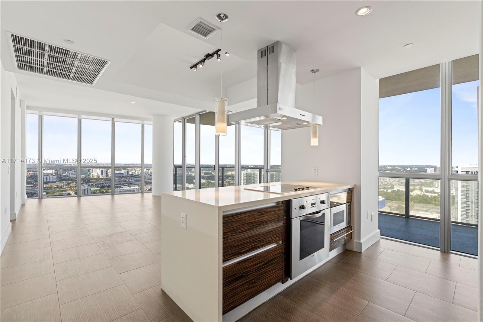 a view of a kitchen with stove and wooden floor