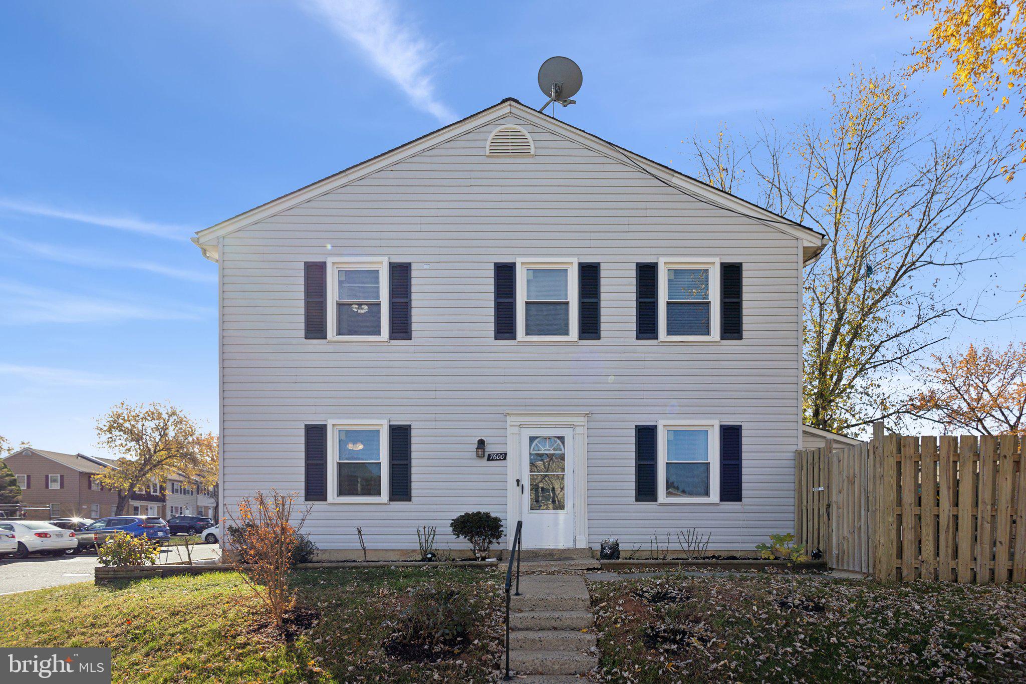 a view of house with a yard