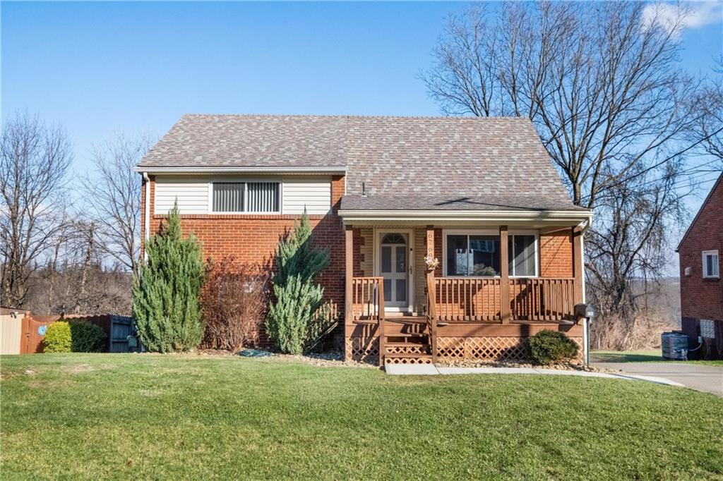 a view of a house with a yard and sitting area