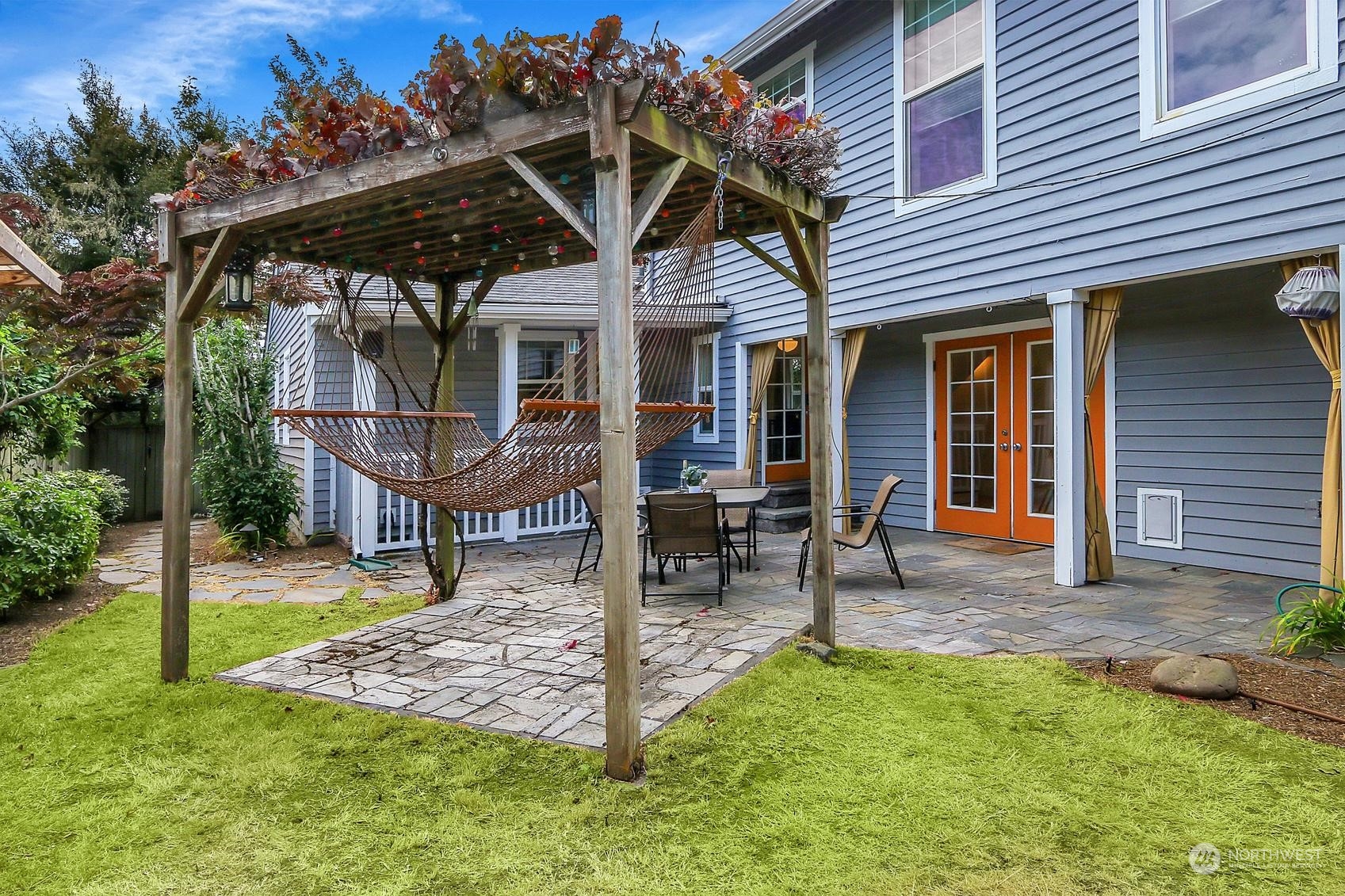 a view of a house with a yard and sitting area