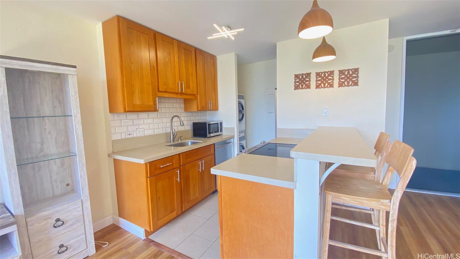 a kitchen that has a sink and a stove in it