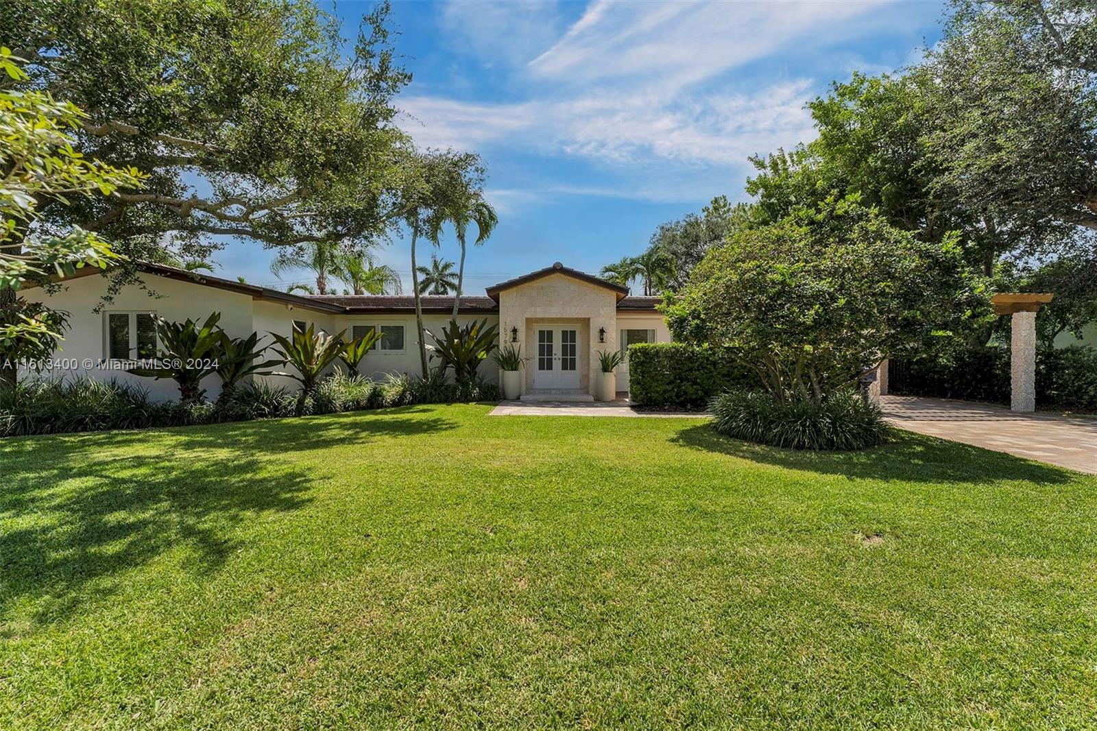 a front view of a house with garden