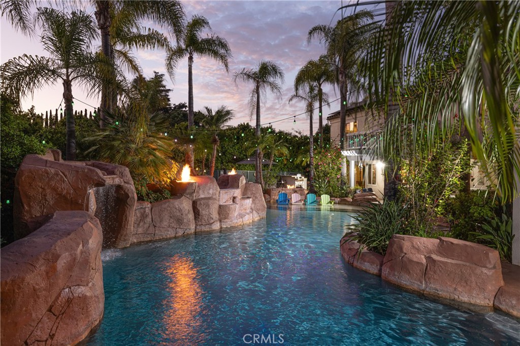 a view of a backyard and swimming pool